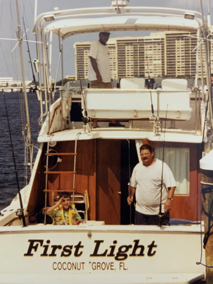 A young angler and crew aboard the First Light sportfisherman in Coconut Grove, Miami