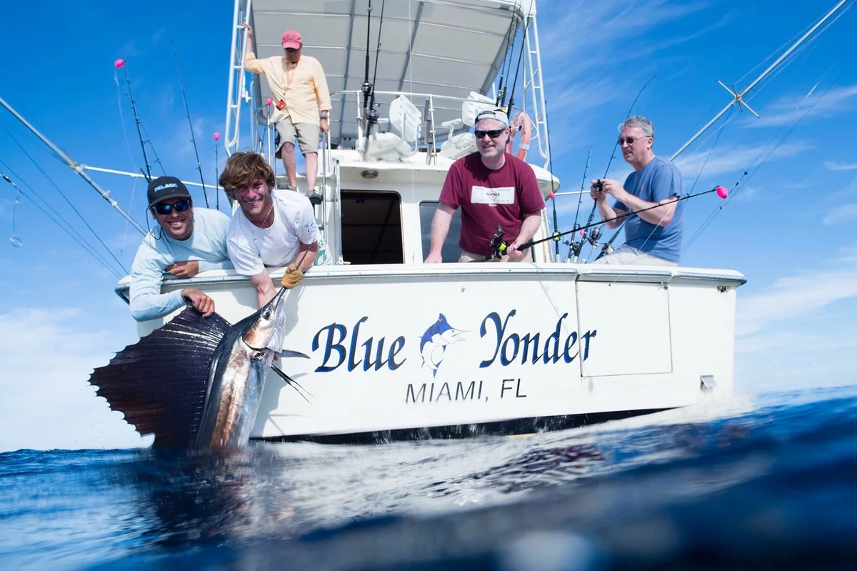 The crew aboard the Blue Yonder with a sailfish boatside off Miami