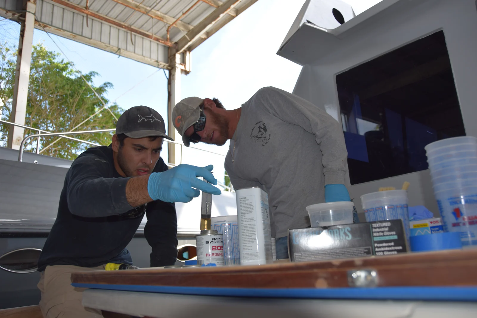 Mixing West System epoxy and hardener for fiberglass work in the cockpit