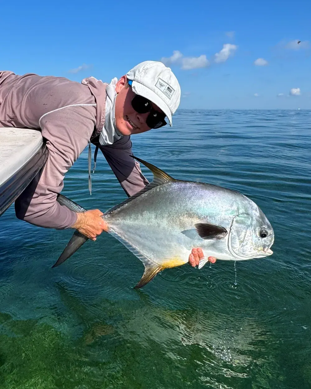 Angler releasing a permit on a full-day Miami inshore charter on Biscayne Bay