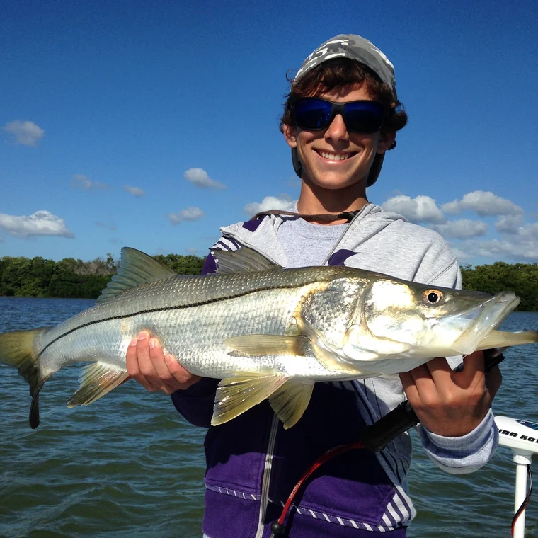 A young angler with a snook caught on a Miami inshore trip