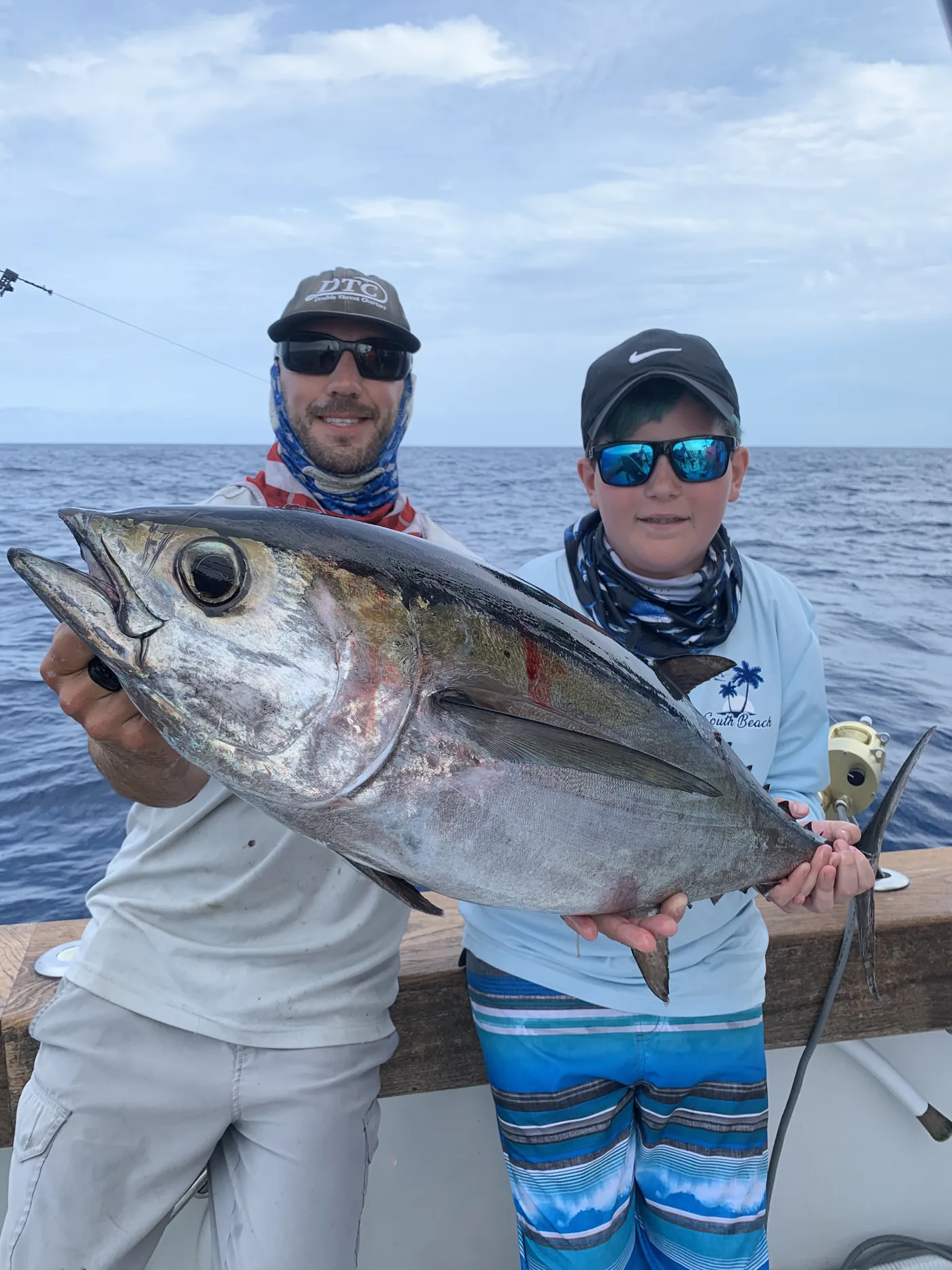 Young angler and captain with a blackfin tuna off Miami