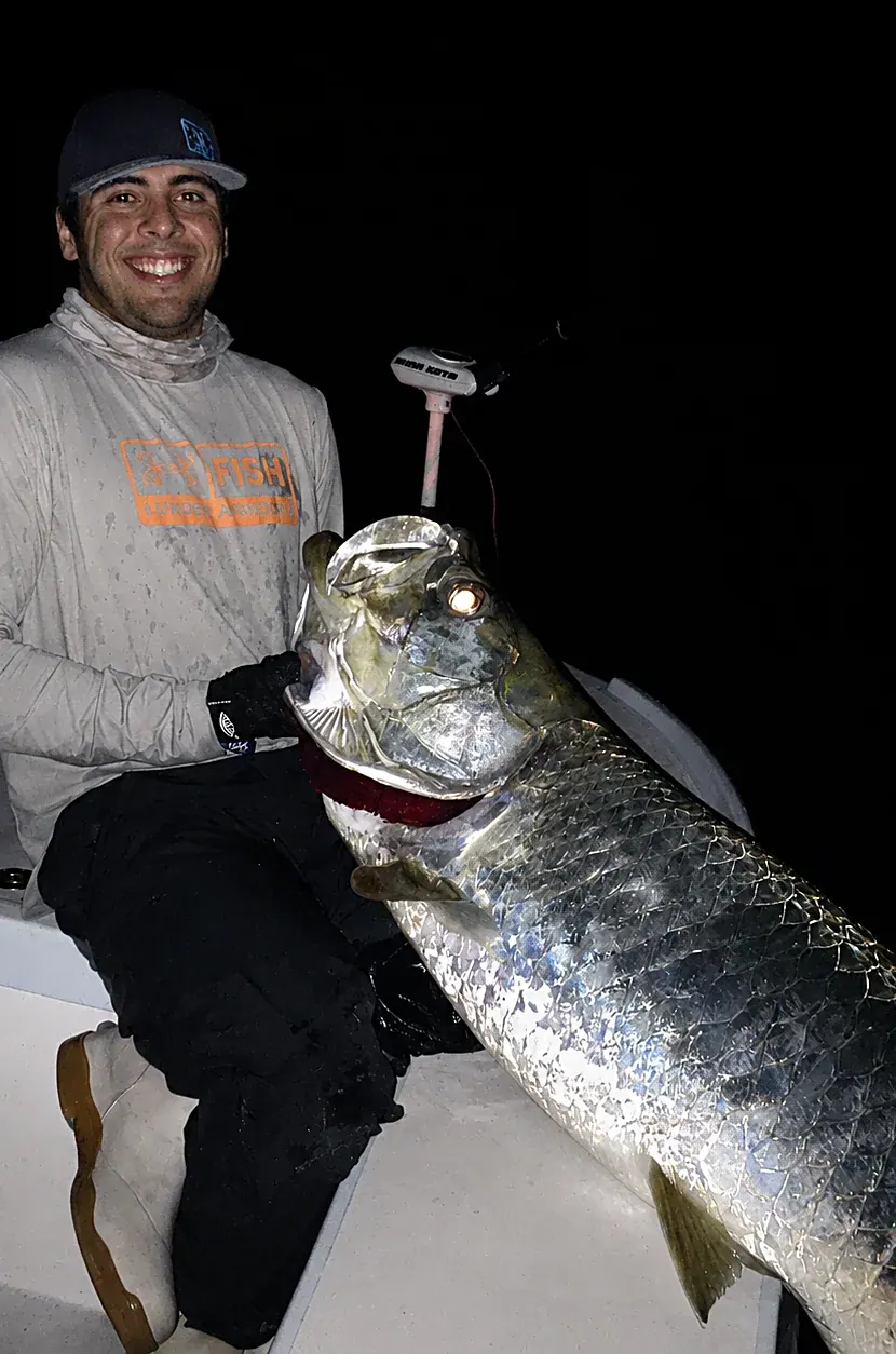 A tarpon landed on a nighttime Miami charter