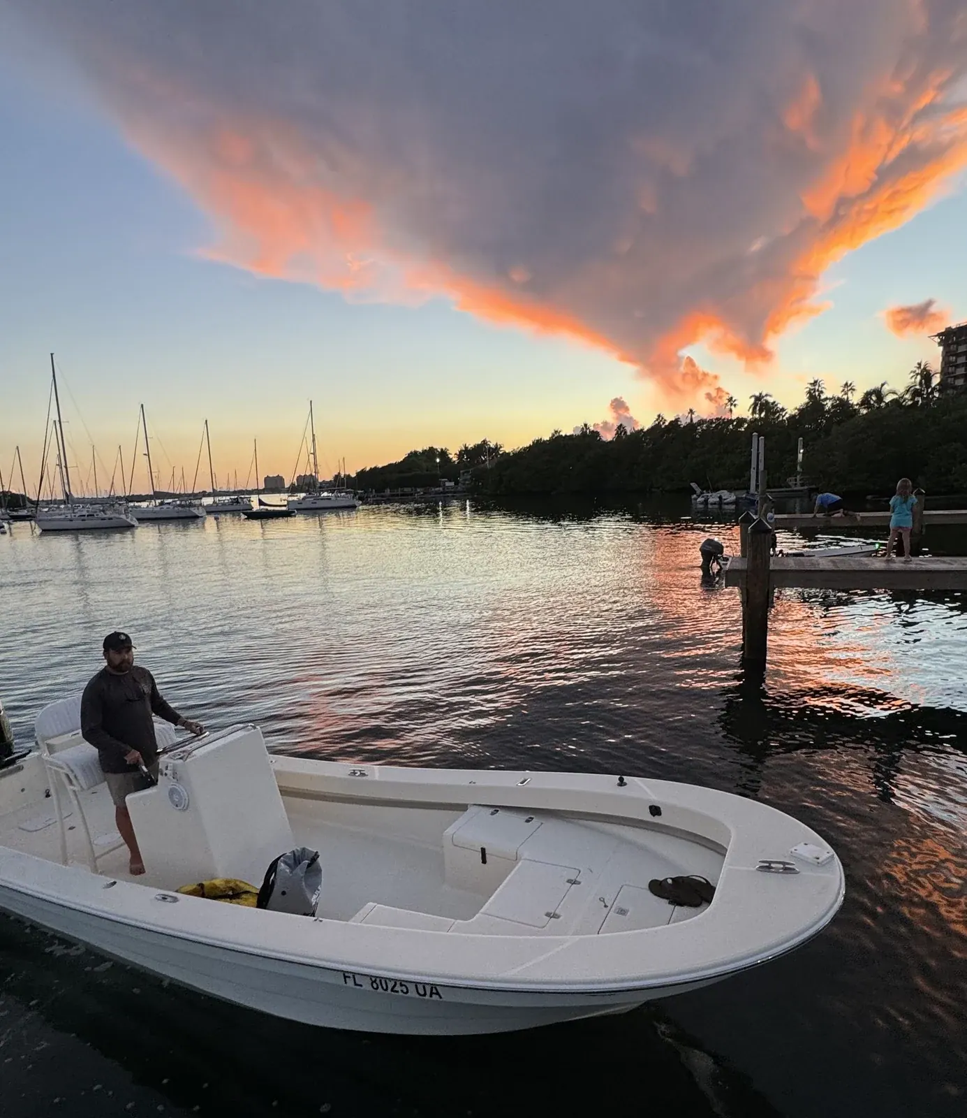 Double Threat’s 22-foot bay boat at the dock at dusk, rigged for night fishing Miami’s lit waters