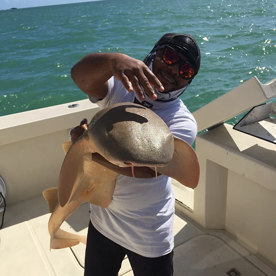Monster Mike with a nurse shark aboard the boat