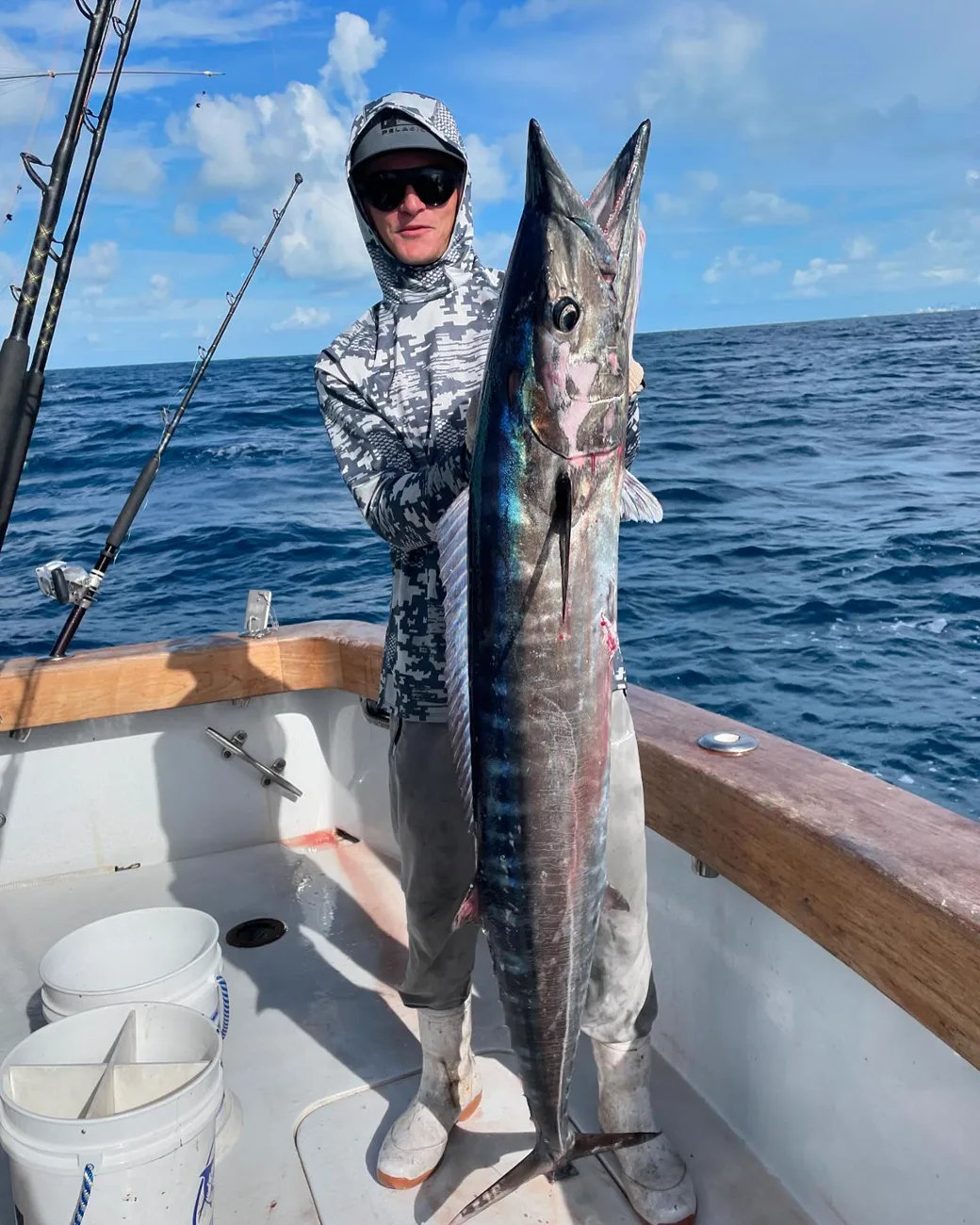 An angler holding a nice wahoo caught on the planer off Miami