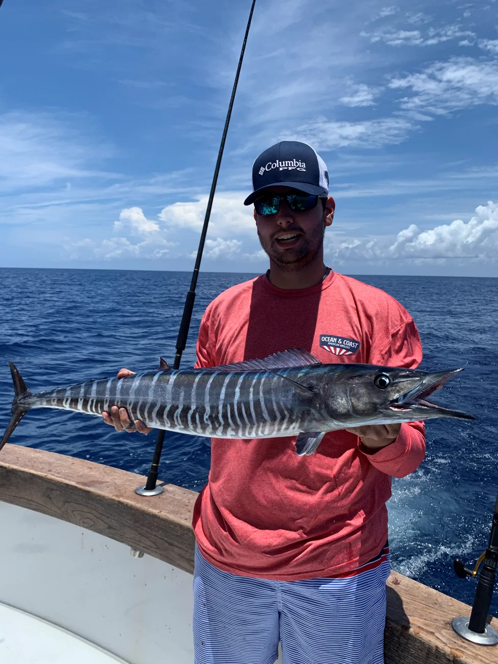 An angler holding a wahoo caught off Miami